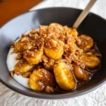 Caramelized bananas with Cinnamon Toast Crunch crumble and vanilla ice cream, drizzled with buttery rum sauce.