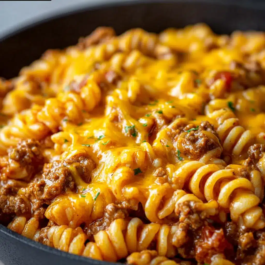 Creamy Cheesy Sloppy Cheeseburger Pasta in a skillet, topped with chopped parsley and diced pickles.