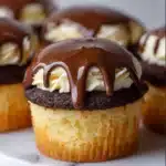 Close-up of Boston Cream Pie Cupcakes with rich chocolate ganache and creamy custard filling