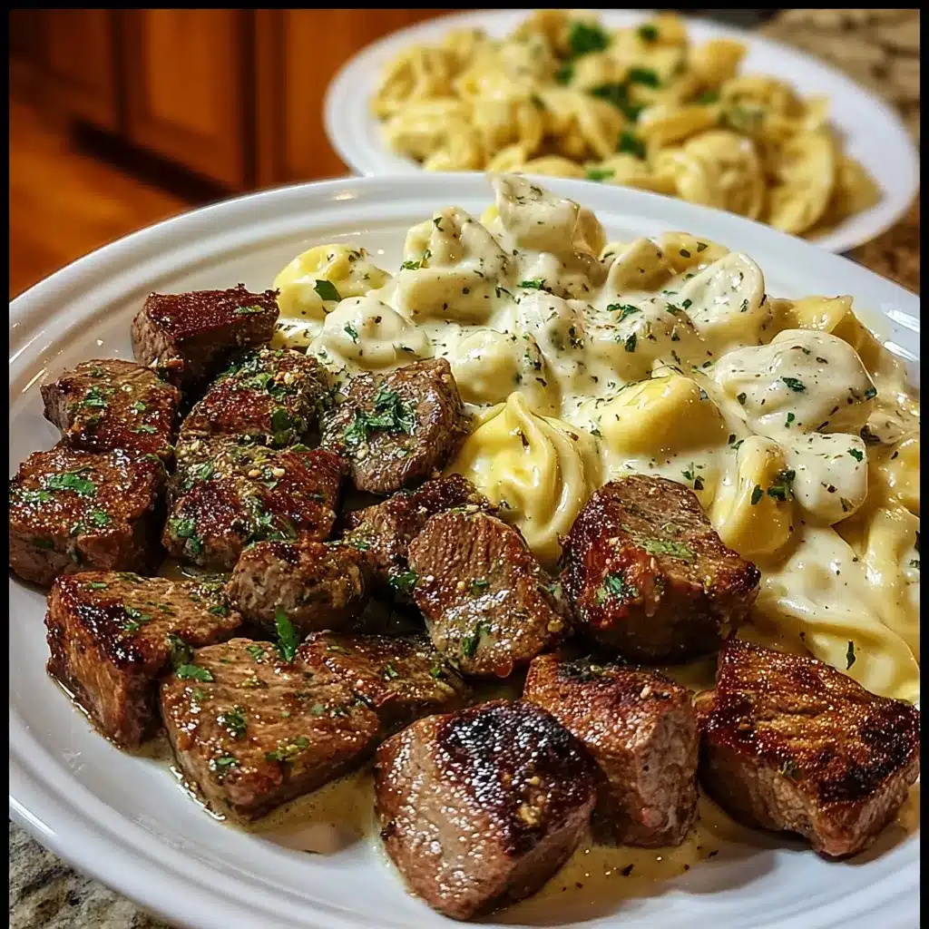 Creamy garlic butter steak bites served with tortellini in Alfredo sauce in a white skillet.
