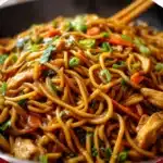 Fresh Chicken Lo Mein with colorful bell peppers, shredded cabbage, and glossy savory sauce.