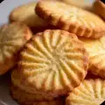 Golden French Butter Cookies (Sablés Bretons) on parchment — classic buttery cookies fresh from the oven.