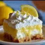 Creamy Lemon Fluff Dessert served in a bowl with whipped cream and lemon zest
