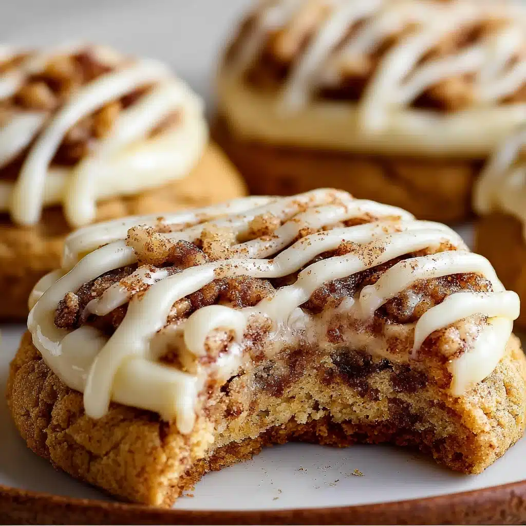 Close-up of soft cinnamon roll cheesecake cookies with creamy filling and cinnamon swirl drizzle.